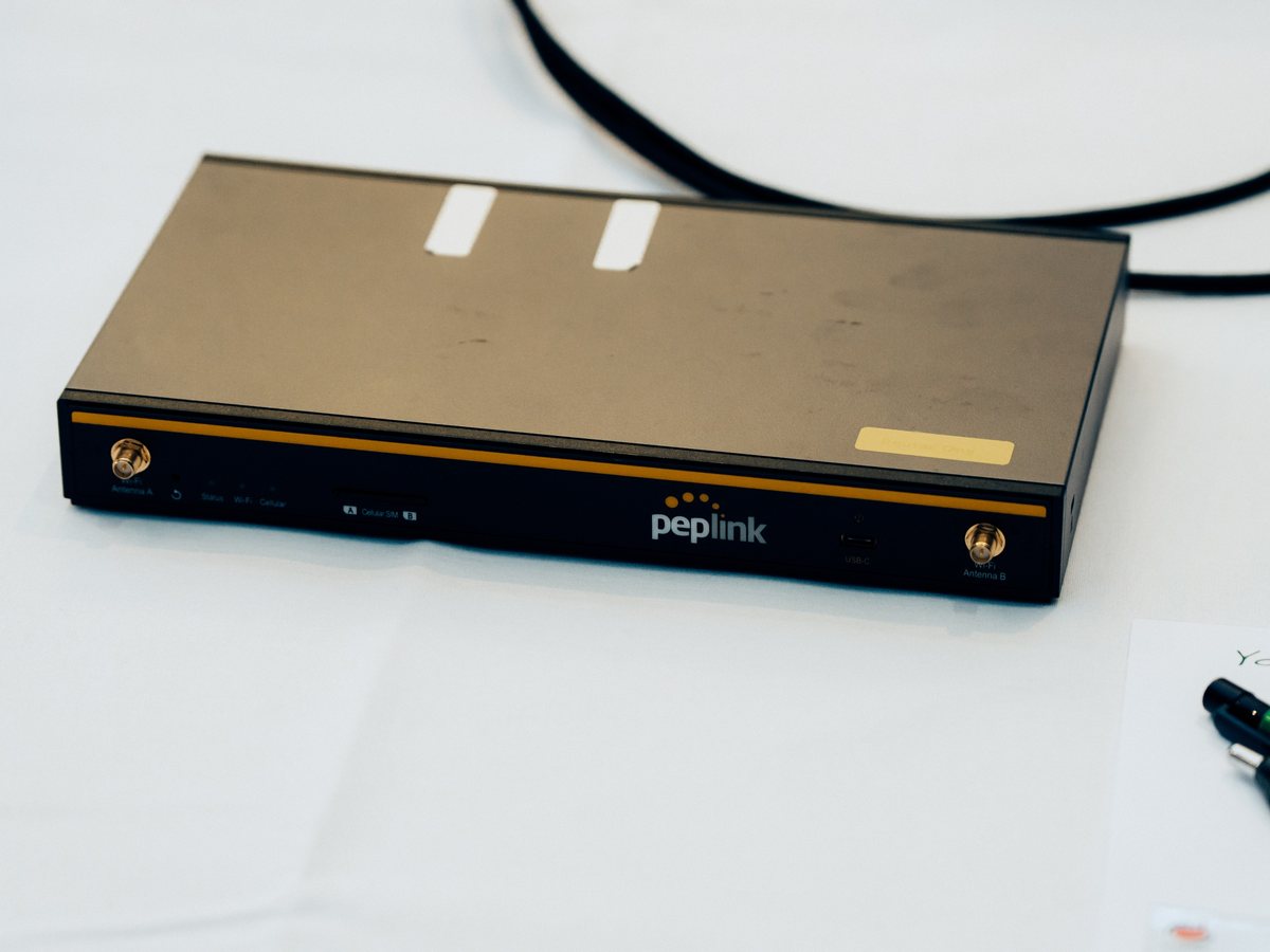 A Peplink router on a delegate's bench